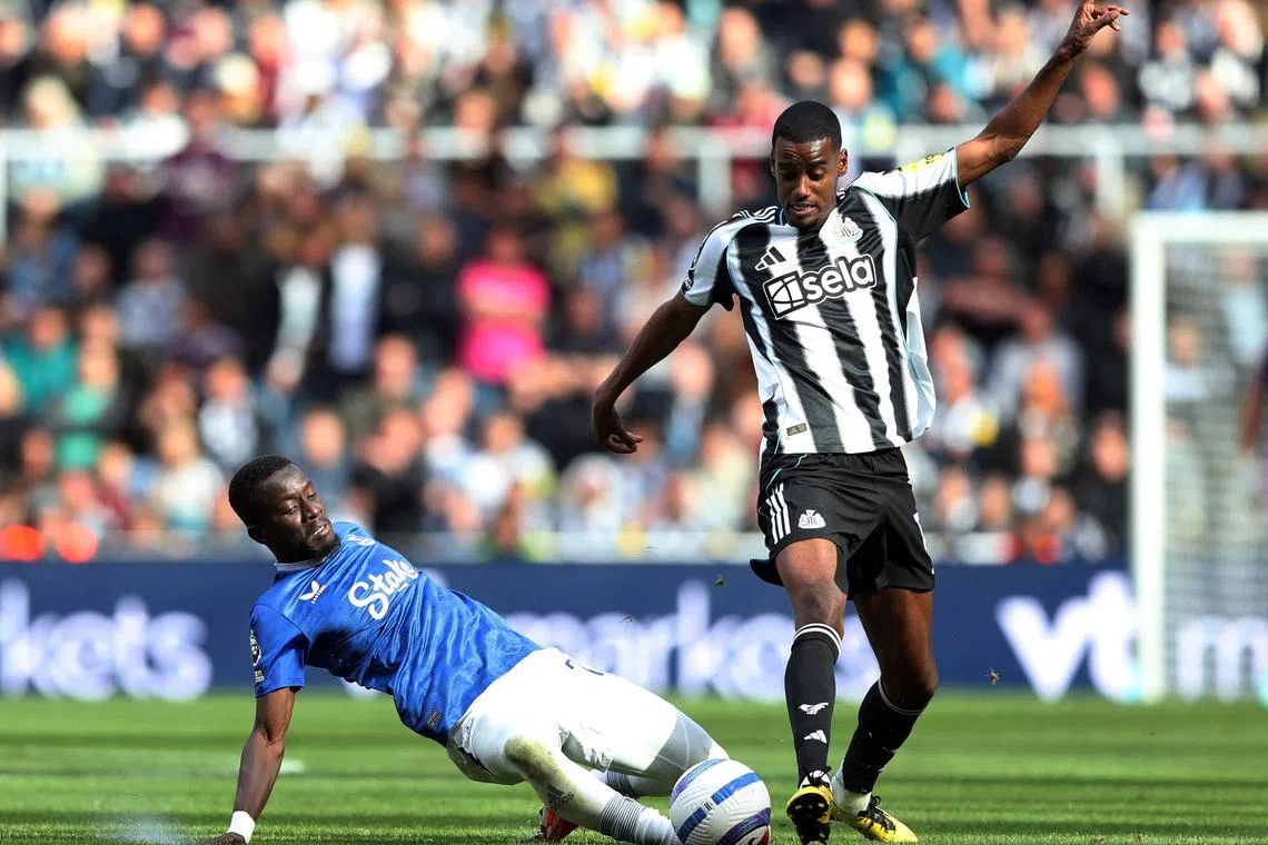 Newcastle United's Alexander Isak in action with Everton's Idrissa Gueye in the English Premier League.
