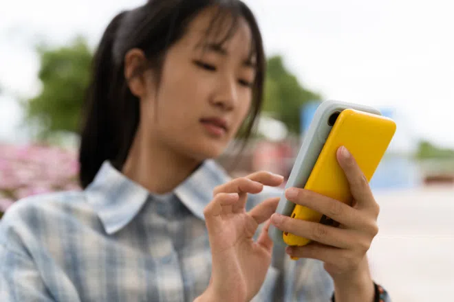 Woman charging her phone with a power bank