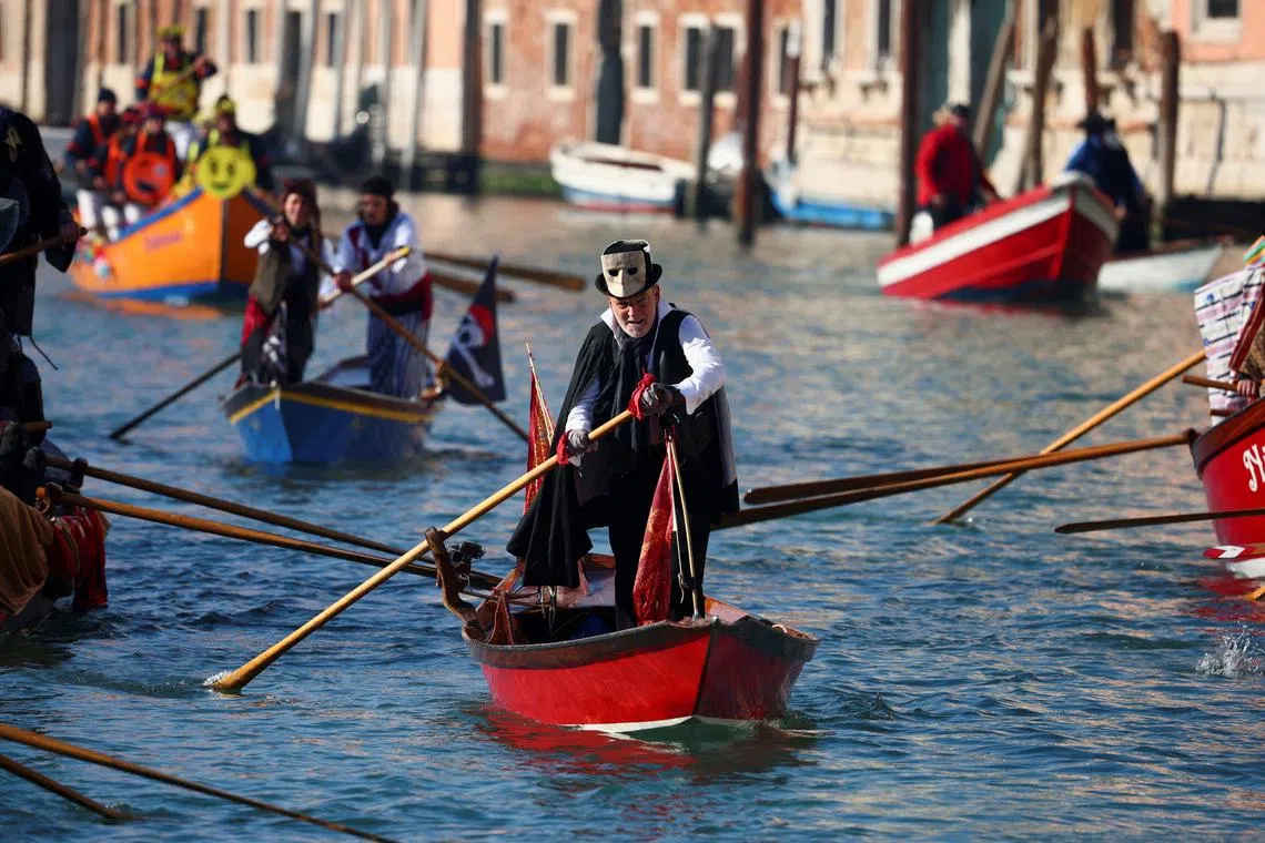 Revellers rowing during the masquerade parade on the Grand Canal during the Venice Carnival, in Venice, Italy Jan 28, 2024. 