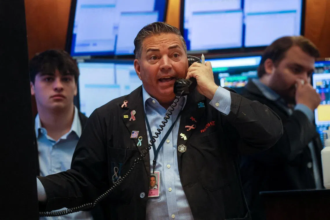 Traders work on the floor of the New York Stock Exchange, in New York City.