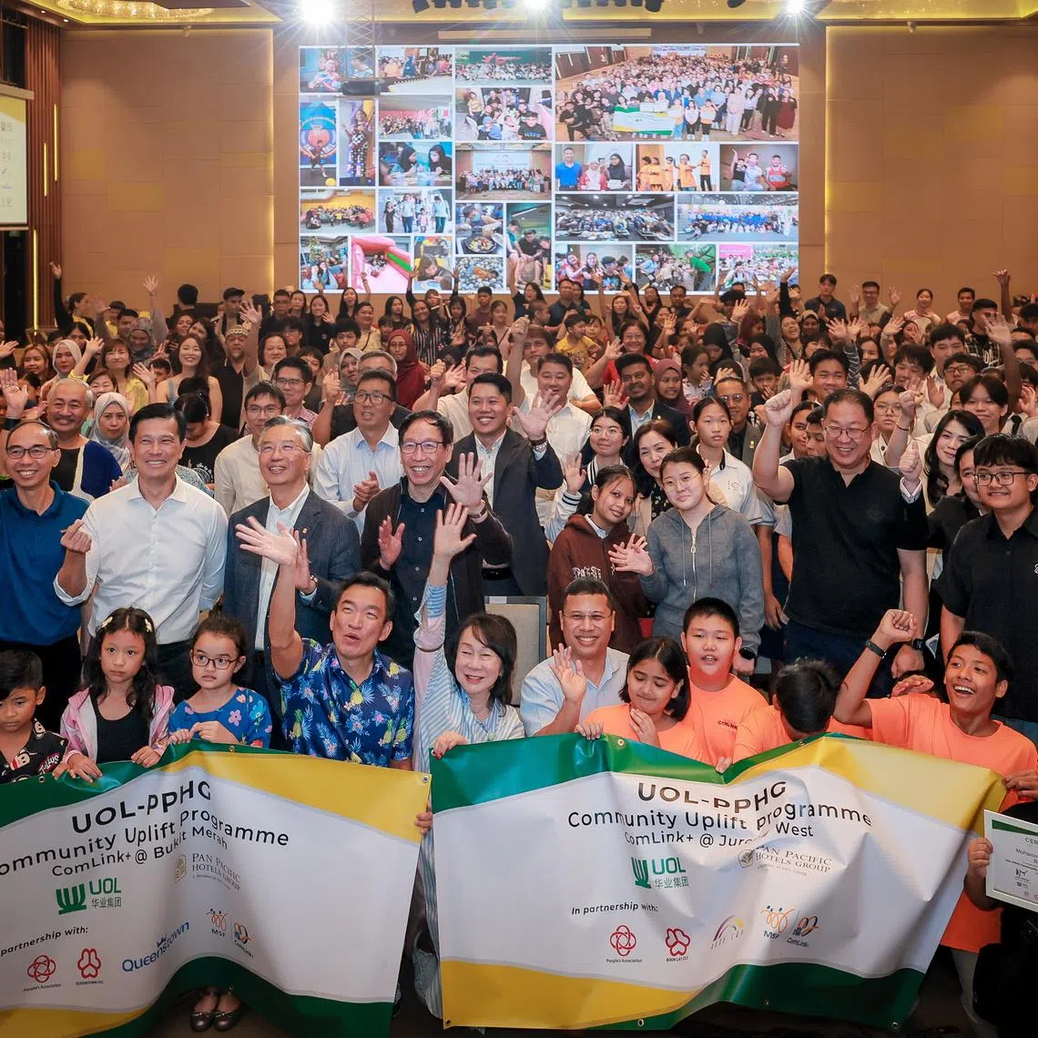 Education Minister Desmond Lee (front row, centre, right) and Senior Parliamentary Secretary for Social and Family Development Eric Chua (front row, centre, left) at the annual UOL-PPHG Community Uplift Programme awards ceremony.