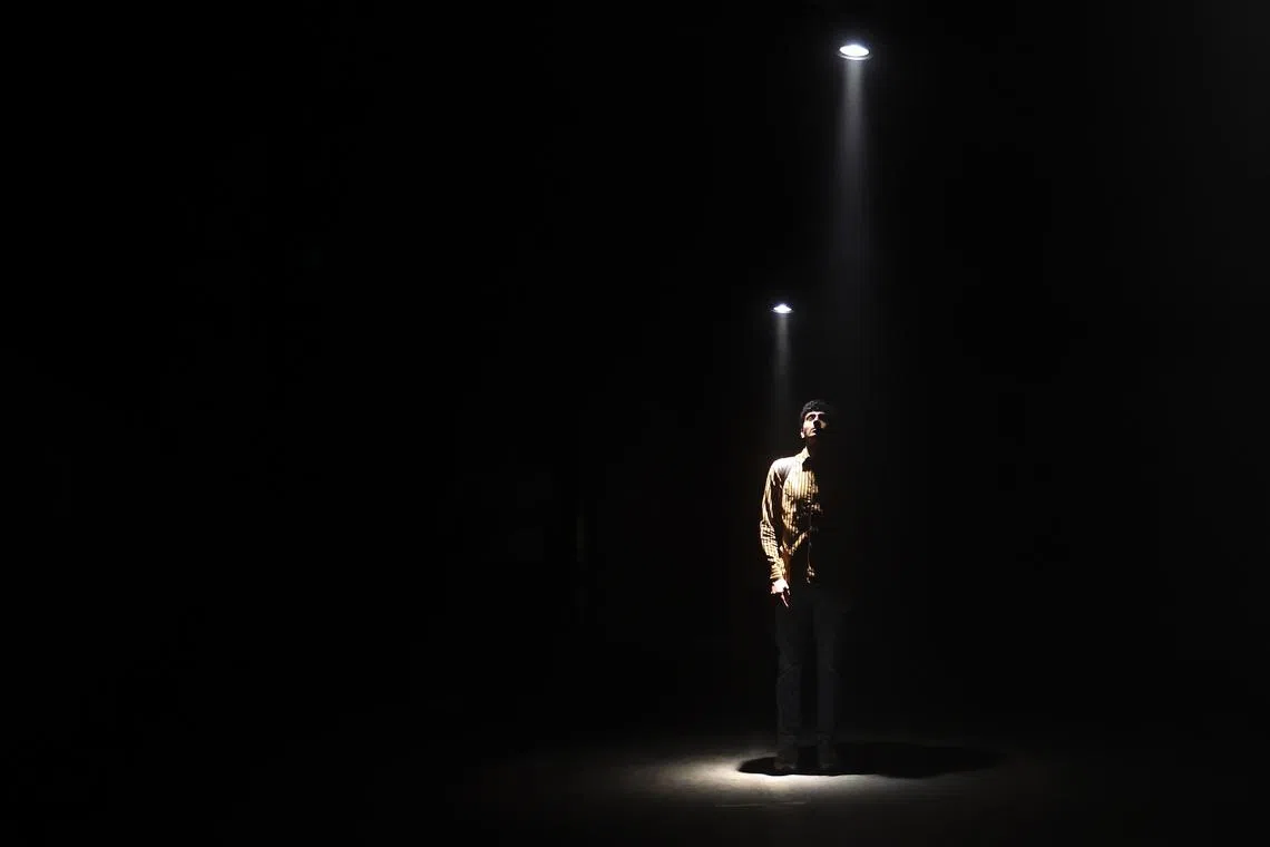 A visitor standing in the light during the UVA Synchronicity exhibit during Frieze Week in London, Britain, Oct 10.