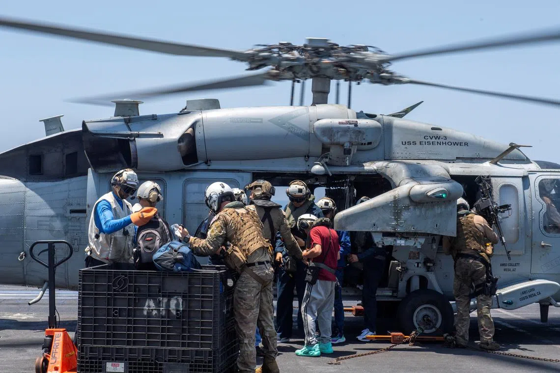 Sailors from the Dwight D. Eisenhower Carrier Strike Group assist distressed mariners rescued from the Liberian-flagged, Greek-owned bulk carrier M/V Tutor that was attacked by Houthis, in the Red Sea, June 15, 2024.  U.S. Naval Forces Central Command/U.S. 5th Fleet/Handout via REUTERS/File Photo