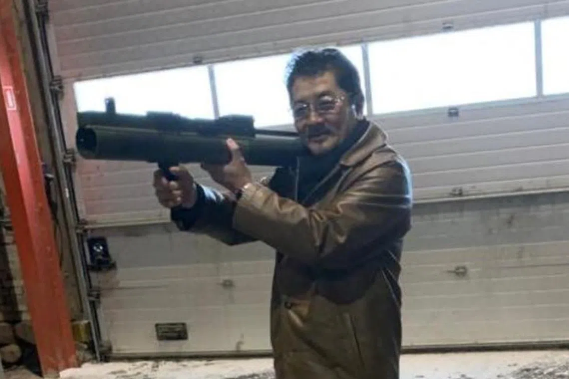 Yakuza boss Takeshi Ebisawa poses with a rocket launcher during a sting operation in Denmark in 2021. 