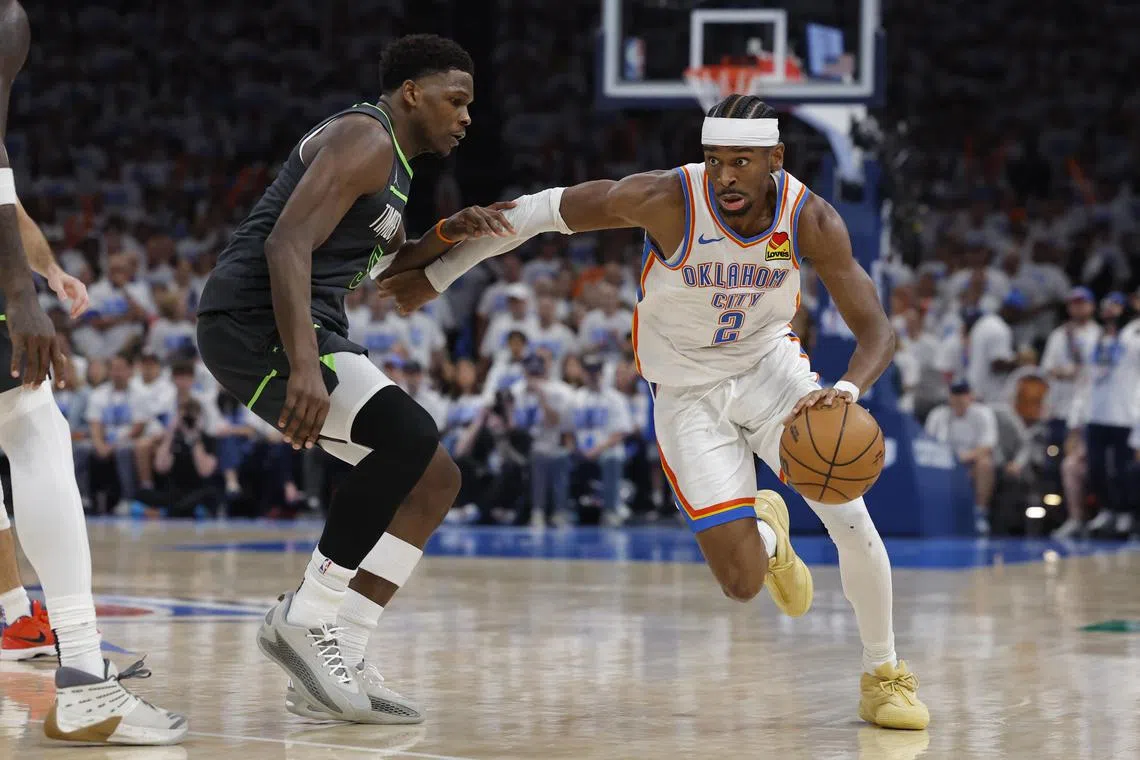 Oklahoma City Thunder guard Shai Gilgeous-Alexander (right) drives against Minnesota Timberwolves guard Anthony Edwards during game one of the western conference finals.