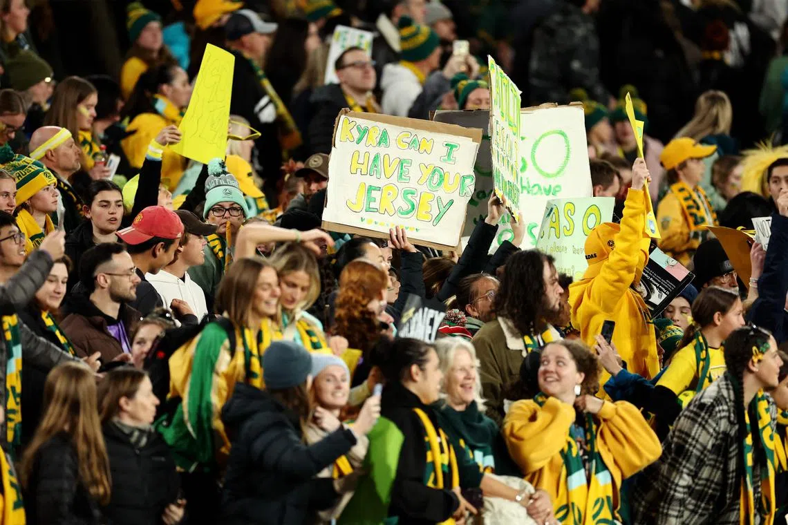 Australian team fans celebrate victory at the end of a friendly women's football match between the Matildas and China at Accor Stadium in Sydney on June 3.