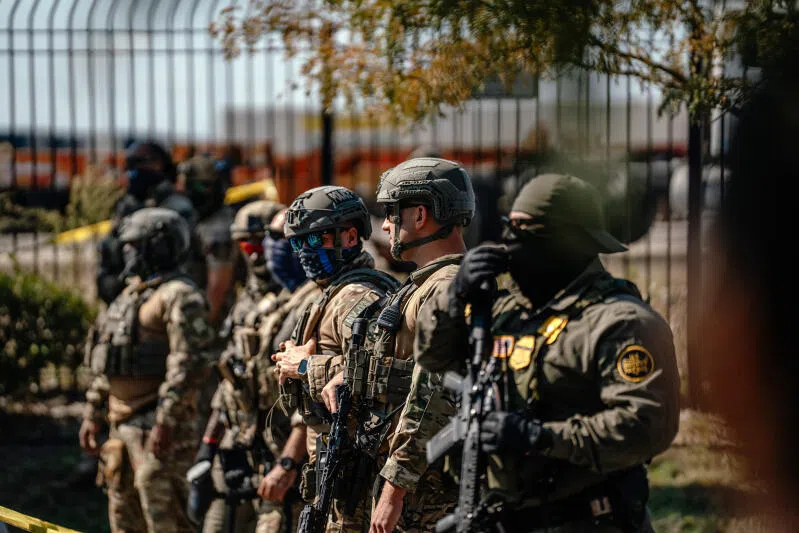 Federal law enforcement officers line up in the Brighton Park neighbourhood in Chicago, on Oct 4, 2025.