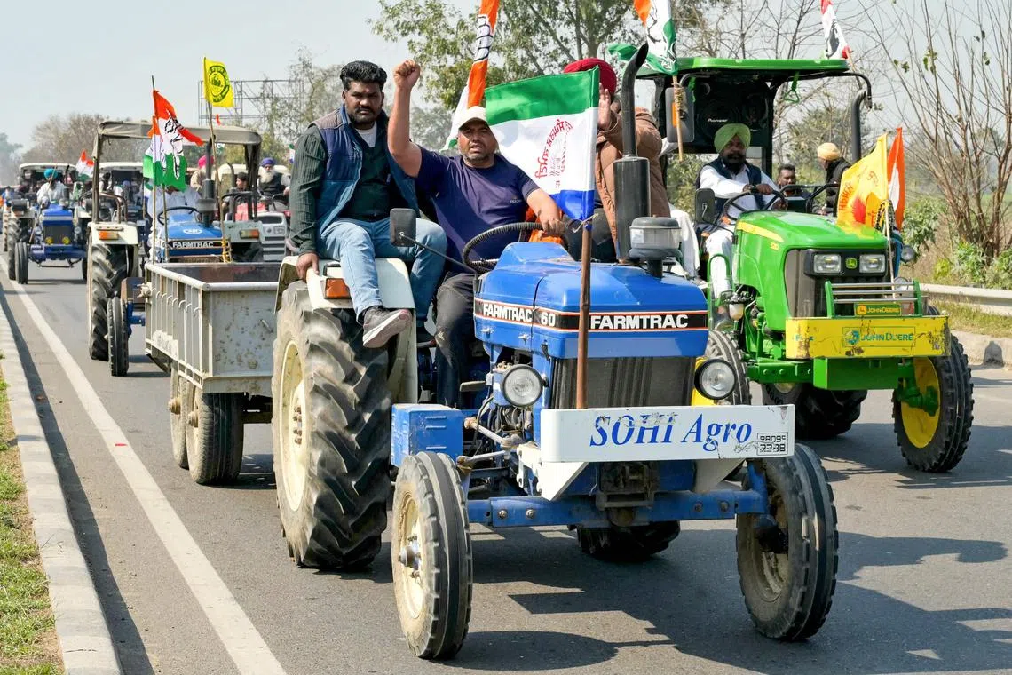 Members of India's Congress party along with protesting farmers demand minimum crop prices in a rally against the central government on the outskirts of Amritsar on Feb 28, 2024.