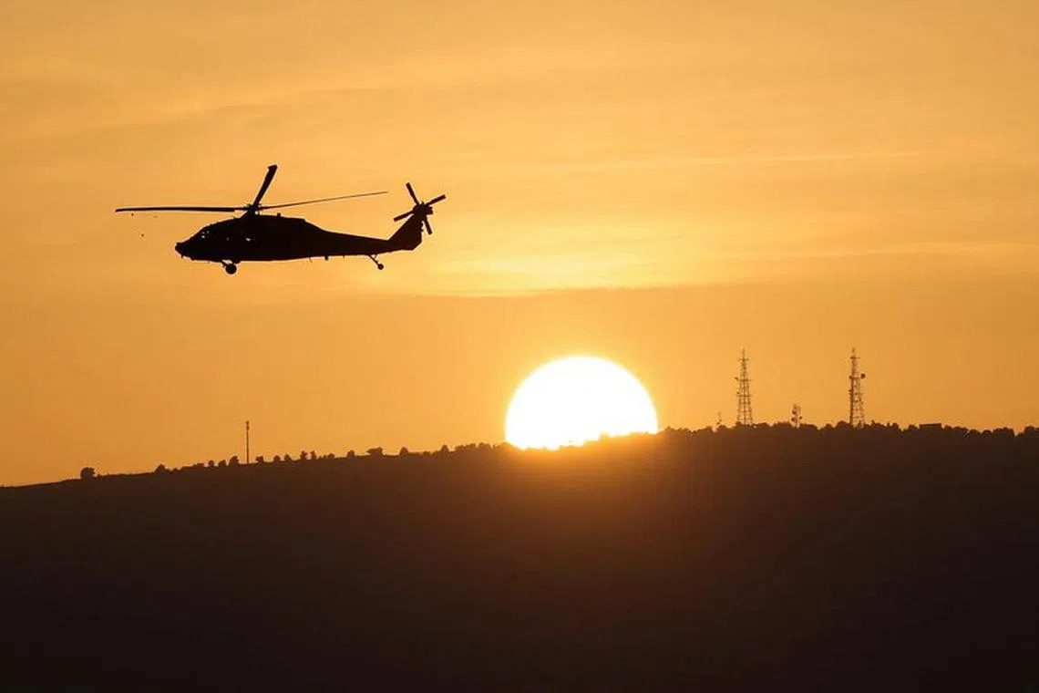 An Israeli military helicopter flies over Northern Israel near the border with Lebanon November 2, 2023. REUTERS/Violeta Santos Moura/ File Photo