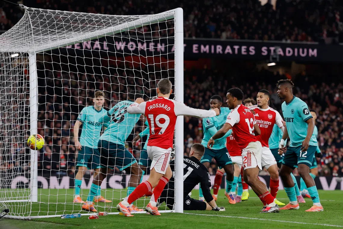 Soccer Football - Premier League - Arsenal v Wolverhampton Wanderers - Emirates Stadium, London, Britain - December 13, 2025 Wolverhampton Wanderers' Sam Johnstone scores Arsenal's first with an own goal. Action Images via Reuters/Andrew Couldridge