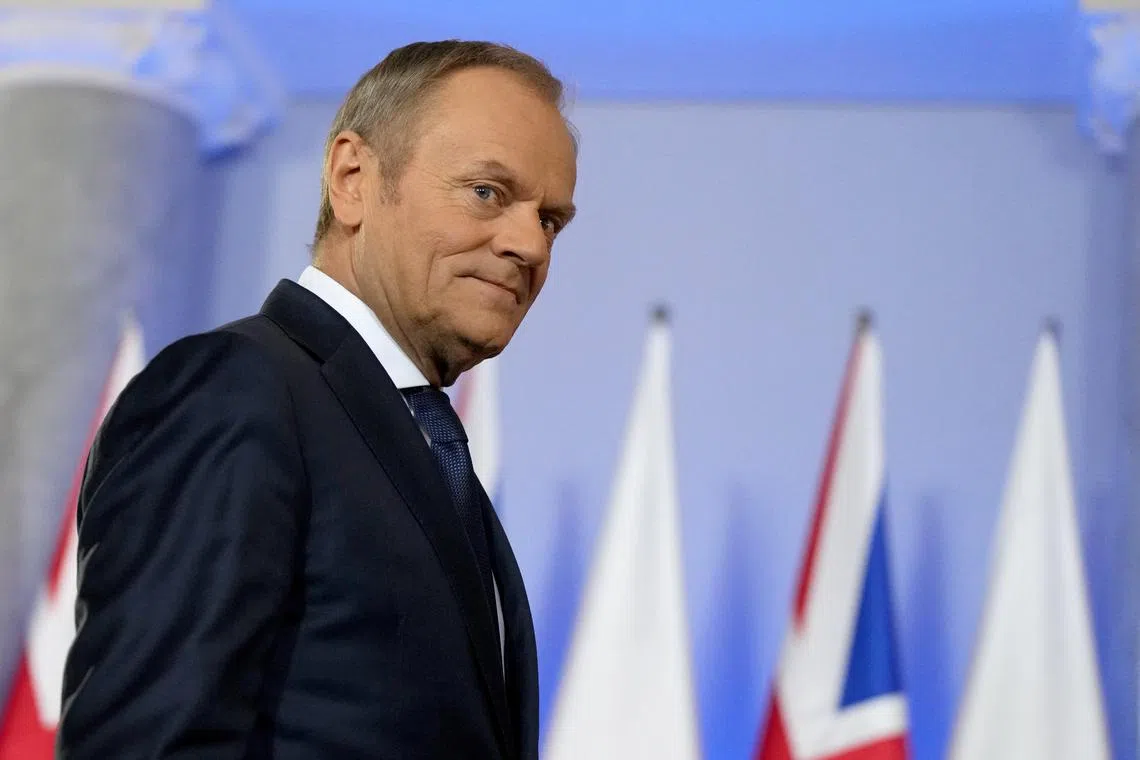 Polish Prime Minister Donald Tusk walks to meet British Prime Minister Rishi Sunak at the Chancellery of the Prime Minister in Warsaw, Poland, April, 23, 2024. REUTERS/Aleksandra Szmigiel