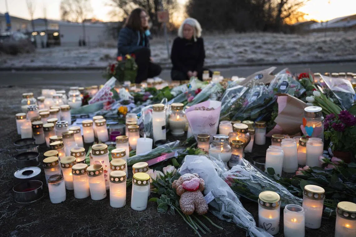 People light candles at a makeshift vigil near the adult education center Campus Risbergska school in Orebro, Sweden, on February 6, 2025 two days after a shooting there left eleven people dead. Several long-barrelled weapons have been found at an adult education centre in Sweden where a gunman killed 10 people, a police spokesman told AFP on February 6. Wednesday's shooting at Campus Risbergska, a school for young adults in Orebro, was Sweden's worst massacre. (Photo by Jonathan NACKSTRAND / AFP)