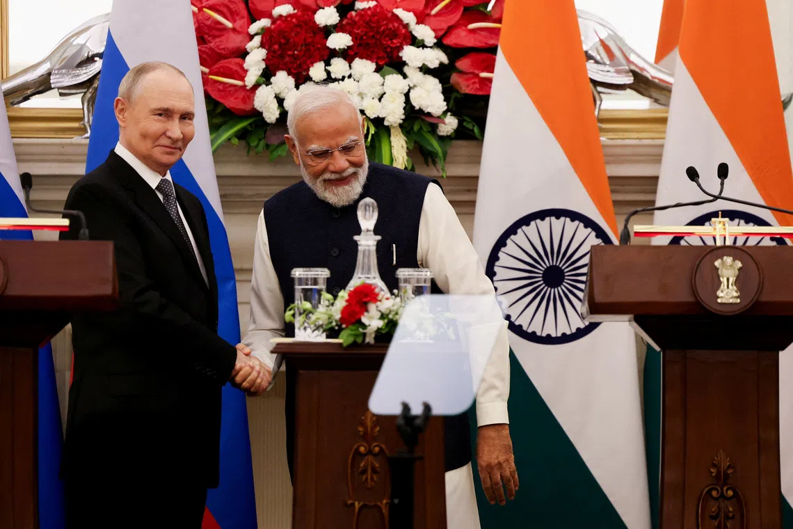 FILE PHOTO: Russian President Vladimir Putin and India's Prime Minister Narendra Modi shake hands as they attend a presentation of a joint statement after their delegation level talks at Hyderabad House in New Delhi, India, December 5, 2025. REUTERS/Adnan Abidi/File Photo