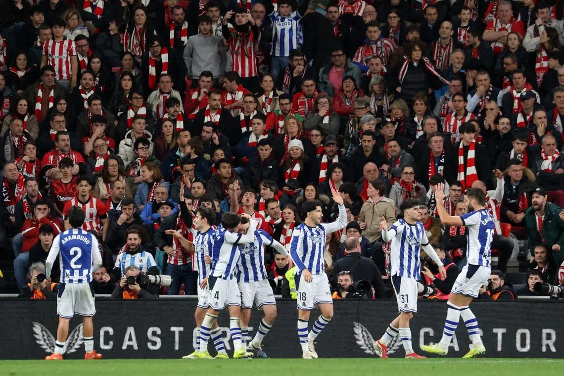 Soccer Football - Copa del Rey - Semi Final - First Leg - Athletic Bilbao v Real Sociedad - San Mames, Bilbao, Spain - February 11, 2026 Real Sociedad's Benat Turrientes celebrates scoring their first goal with teammates REUTERS/Pankra Nieto