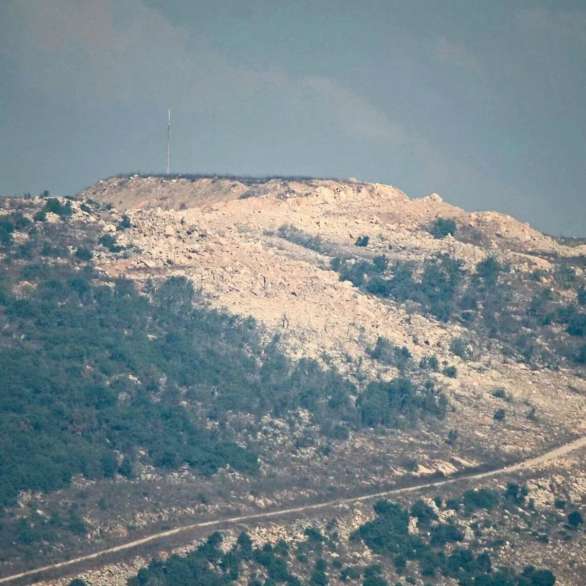 The Ali al-Taher ridge in southern Lebanon on Sept 7 (left) and the aftermath of an Israeli demolition on Sept 10 which triggered a 4.1-magnitude tremor.
