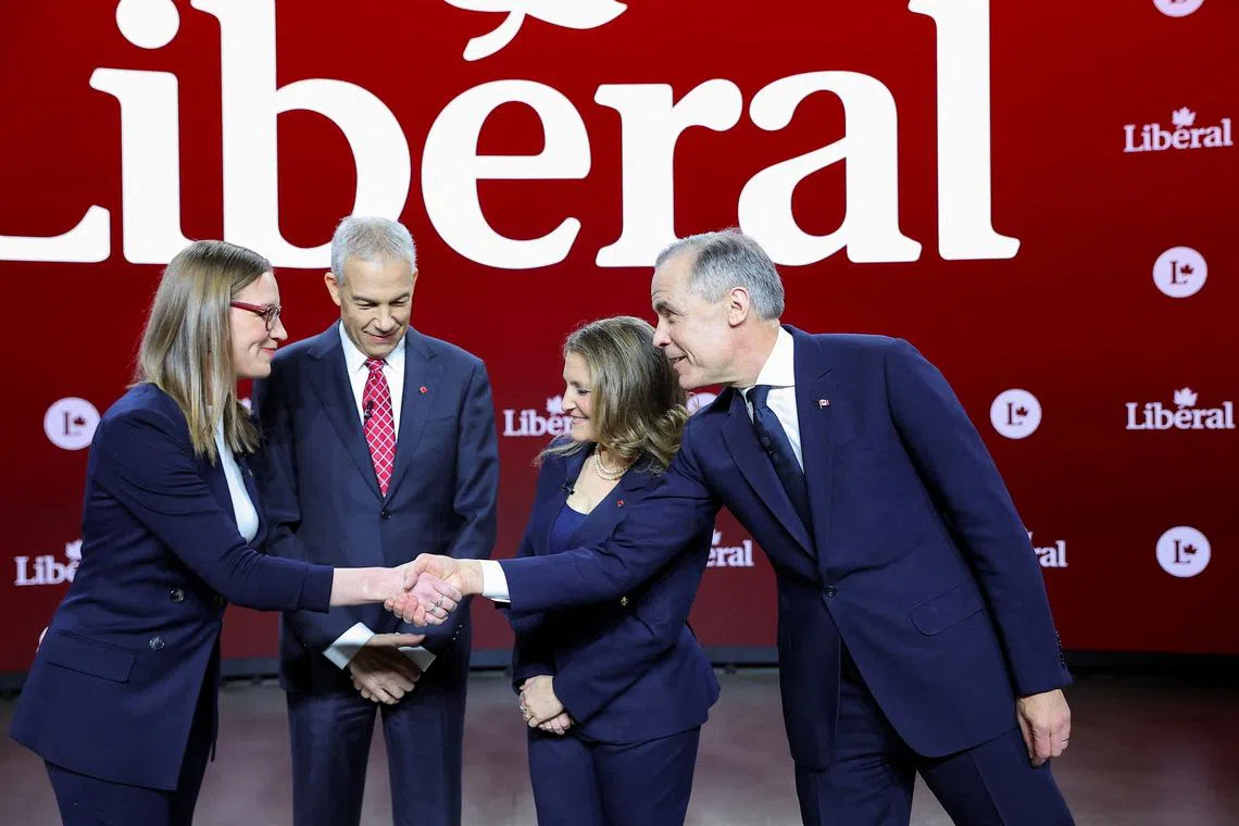 FILE PHOTO: Canada's Liberal Party leadership candidates, former House leader Karina Gould shakes hands with former Bank of Canada governor Mark Carney, near former Liberal MP Frank Baylis, and former Deputy Prime Minister and Finance Minister Chrystia Freeland, on the day of an English language debate ahead of the March 9 vote to replace Prime Minister Justin Trudeau, in Montreal, Quebec, Canada, February 25, 2025.  REUTERS/Evan Buhler/File Photo