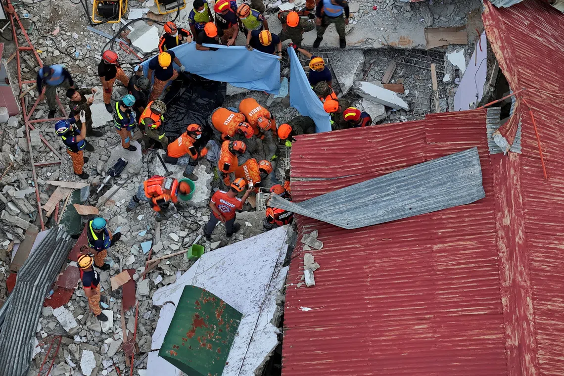 A drone view showing rescue workers conducting a rescue operation at a collapsed building in the aftermath of a magnitude 6.9 quake in Bogo, Cebu, Philippines on Oct 1, 2025. 
