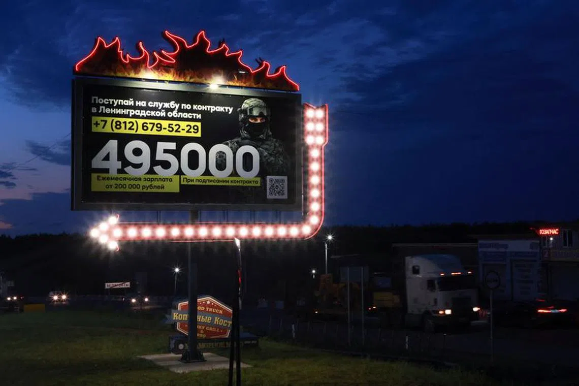 A view shows a billboard promoting military service under the contract in Russian Armed Forces and containing information about payments, on a road in the Leningrad Region, Russia July 4, 2023.  REUTERS/Anton Vaganov/file photo
