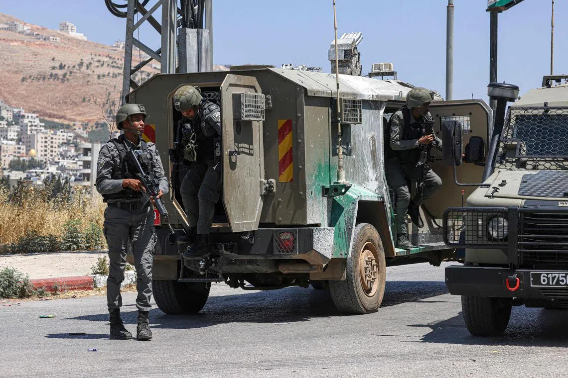 Israeli border police man a checkpoint during an Israeli raid in the Askar camp in the occupied West Bank on June 16, 2025.  