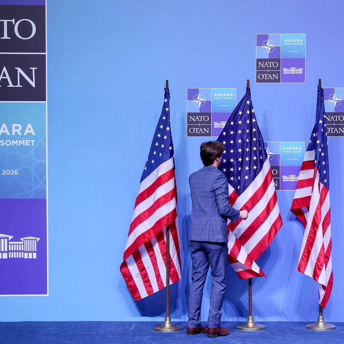 FILE PHOTO: A worker sets the stage with U.S. flags before U.S. President Donald Trump speaks to the media on the day of a NATO leaders' summit in Ankara, Turkey, July 8, 2026. REUTERS/Umit Bektas/File Photo