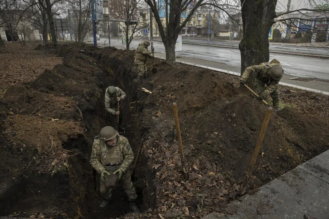 Ukrainian troops dig a trench in the Bakhmut district of eastern Ukraine, on Dec 16, 2022.