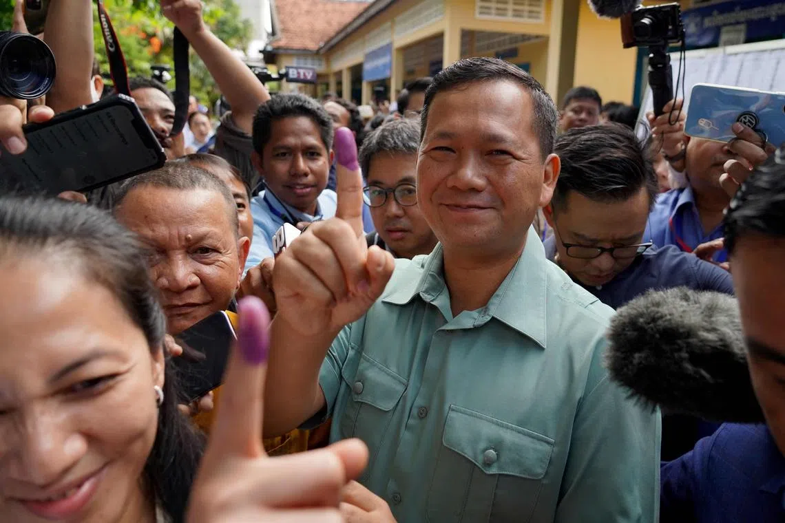 (FILES) Hun Manet, commander of the Royal Cambodian Army and eldest son of Prime Minister Hun Sen, shows his finger after he casts his vote at a polling station in Phnom Penh on July 23, 2023. Cambodian Prime Minister Hun Sen, one of the world's longest-serving leaders, said on July 26, 2023 he will resign and hand power to his son, after almost four decades of hardline rule. (Photo by -STR / AFP)