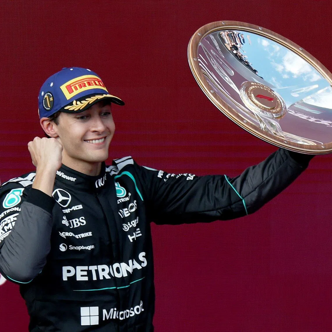Formula One F1 - Australian Grand Prix - Albert Park Grand Prix Circuit, Melbourne, Australia - March 8, 2026 Mercedes' George Russell celebrates with the trophy on the podium after winning the Australian Grand Prix REUTERS/Hollie Adams