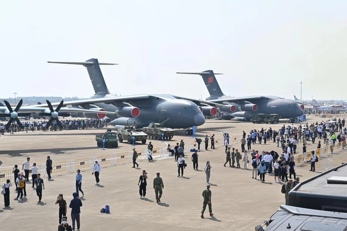 Visitors are seen around planes participating in the 15th China International Aviation and Aerospace Exhibition in Zhuhai, China.