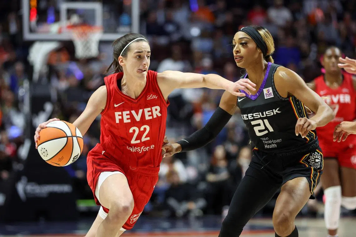 Indiana Fever guard Caitlin Clark (No. 22) driving to the basket defended by Connecticut Sun guard DiJonai Carrington during Game 2 of the first round of the WNBA play-offs.