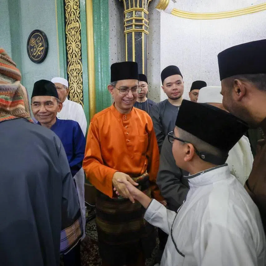 Acting Minister-in-Charge of Muslim Affairs and Senior Minister of State for Home Affairs Muhammad Faishal Ibrahim greeting congregants at Hari Raya Aidilfitri prayers at Masjid Sultan on March 21.