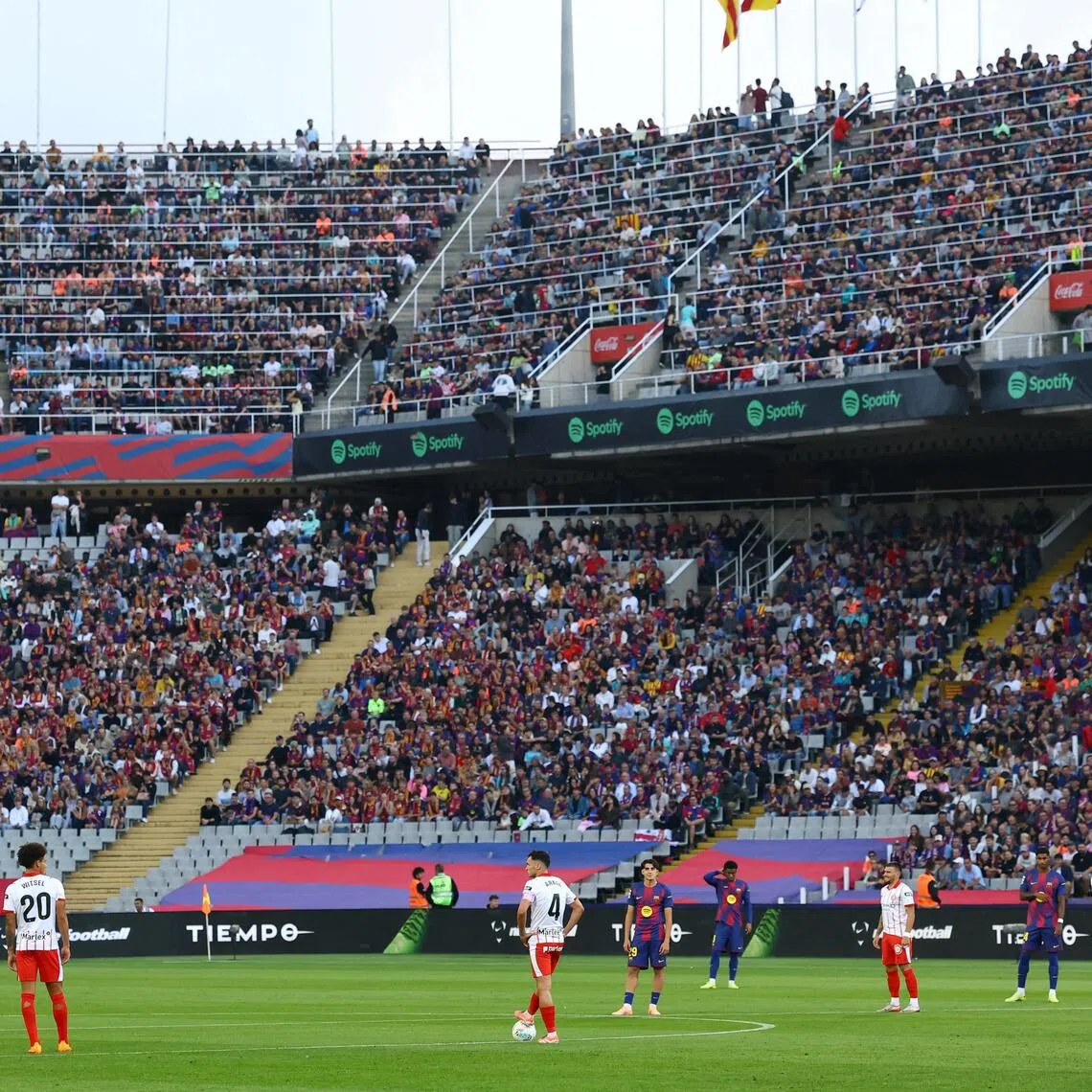 Barcelona and Girona players protesting at kick-off at the  Estadi Olimpic Lluis Company on Oct 18, 2025, due to La Liga's planned relocation of the Villarreal-Barcelona match to Miami. La Liga scrapped the plan on Oct 21.