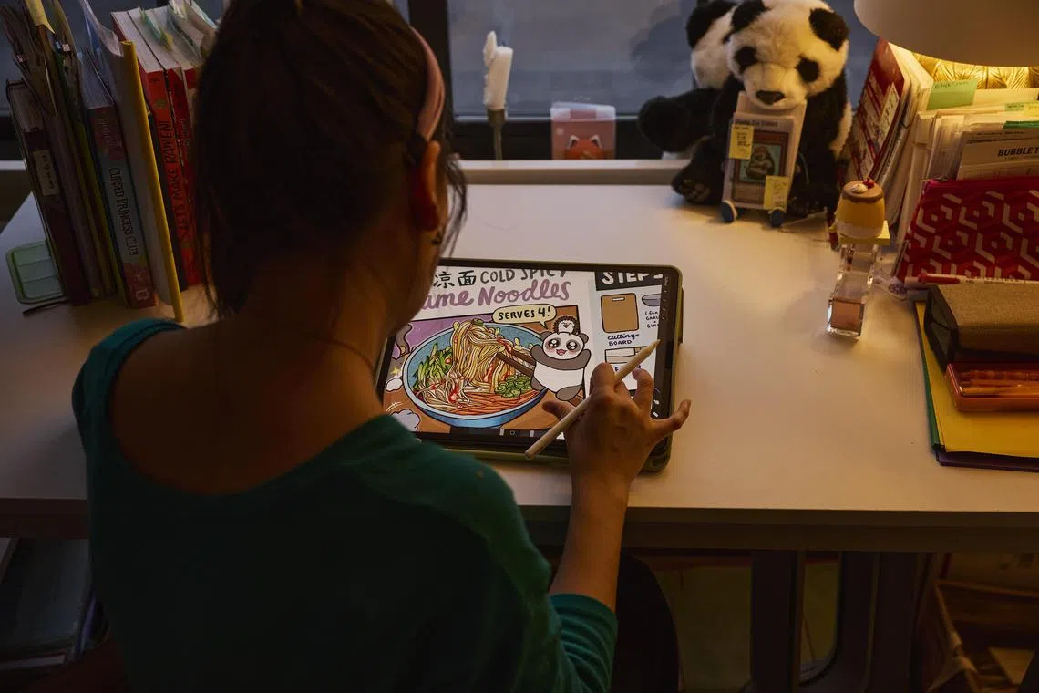Linda Yi works on a drawing at her home in New York, Oct. 11, 2024. YiÕs drawings became the basis of Panda Cub Diner, her online cooking club, focusing on Sichuan dishes. (Nico Schinco/The New York Times)