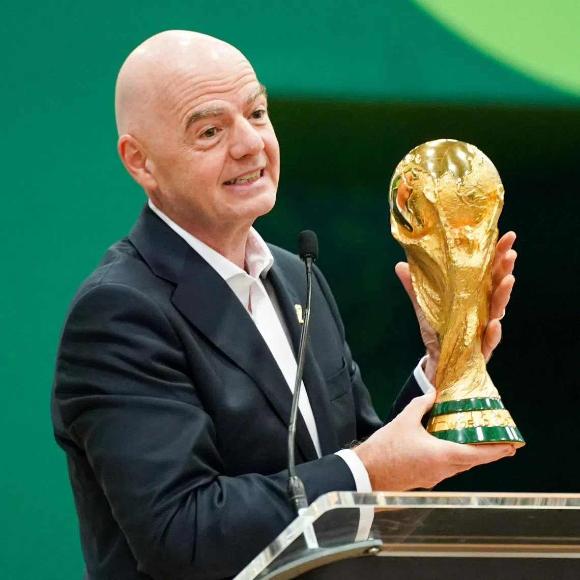 Jun 1, 2026; Dallas, Texas, USA; FIFA President Gianni Infantino holds the World Cup trophy while he speaks during the grand opening of the 2026 FIFA World Cup international broadcast center at Kay Bailey Hutchison Convention Center. Mandatory Credit: Raymond Carlin III-Imagn Images
