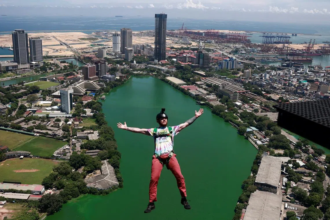 A base jumper leaping off the Lotus Tower, a 351.5 m tall tower, in Colombo, Sri Lanka, on May 13, 2024. 