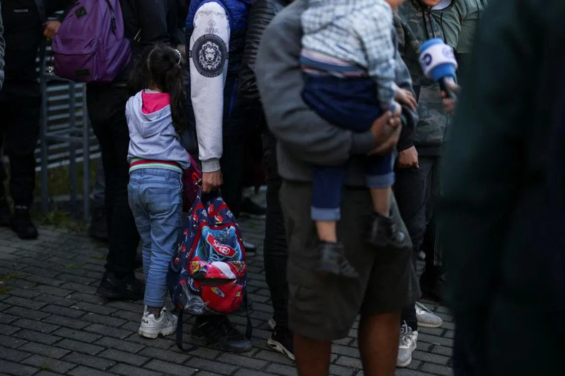 Migrants who were found in a van by police during their patrol along the German-Polish border to prevent illegal migration, gather near Forst, Germany, September 20, 2023. REUTERS/Lisi Niesner/File Photo