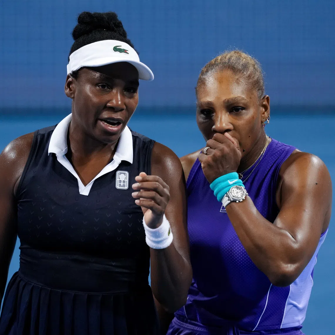 Aug 17, 2026; Mason, OH, USA;  Serena Williams and Venus Williams of the United States talk after a point against Marta Kostyuk of Ukraine and Peyton Stearns of the United States in their doubles match during the Cincinnati Open at Lindner Family Tennis Center. Mandatory Credit: Aaron Doster-Imagn Images