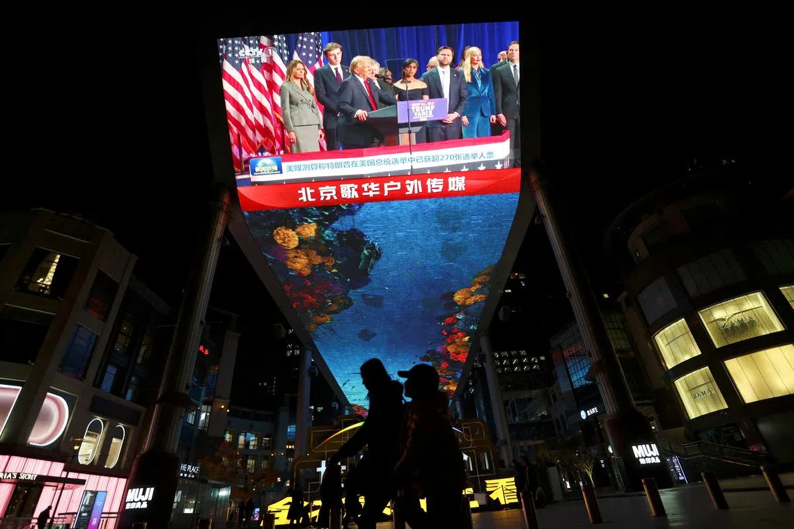A giant screen displays footage of Republican Donald Trump during a news bulletin on the U.S. election, at a shopping complex in Beijing, China November 6, 2024. REUTERS/Florence Lo