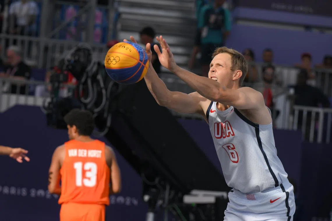 Canyon Barry of Team USA practises an underhand free throw before the game against the team from the Netherlands during the Paris 2024 Olympics 3X3 Basketball Men’s Pool Round at Place de la Concorde on August 4, 2024.