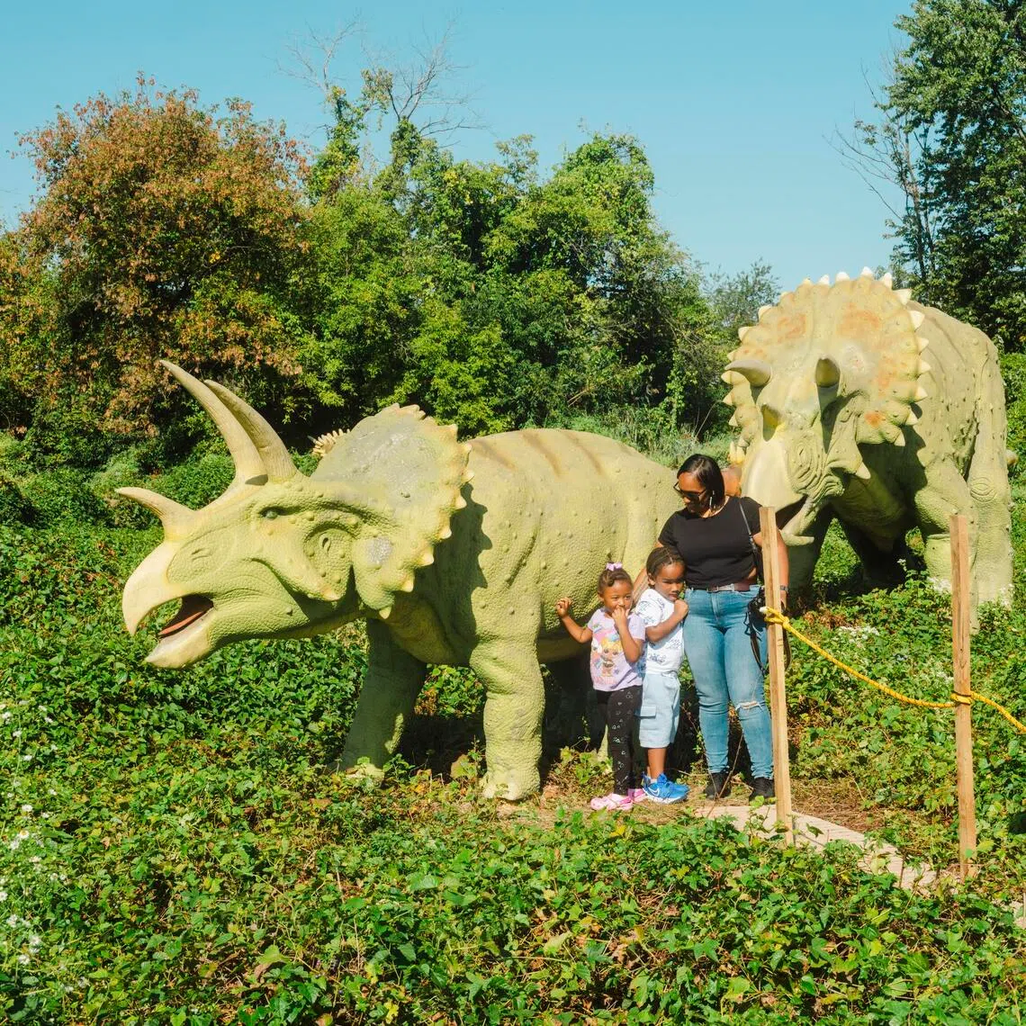 A family visits Field Station: Dinosaurs outdoor theme park in Leonia, N.J. on Sept. 28, 2025. Thirty-one animatronic dinosaurs on display at the theme park Ñ including some that growl and roar Ñ are for sale. (Lanna Apisukh/The New York Times)