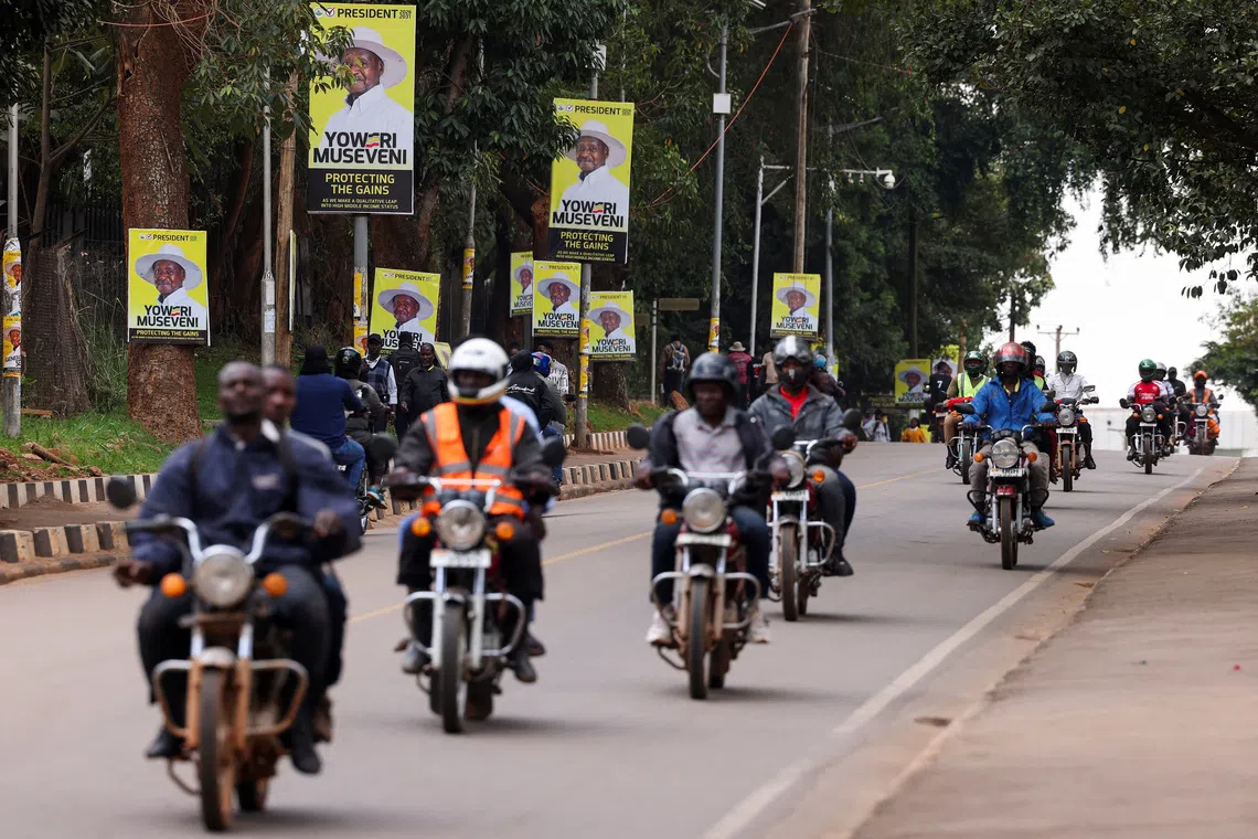 Motorcycle taxis ride past campaign posters of Uganda's President and leader of the ruling National Resistance Movement (NRM) party, Yoweri Museveni, ahead of the upcoming general election in Kampala, Uganda October 13, 2025. REUTERS/Miriam Watsemba