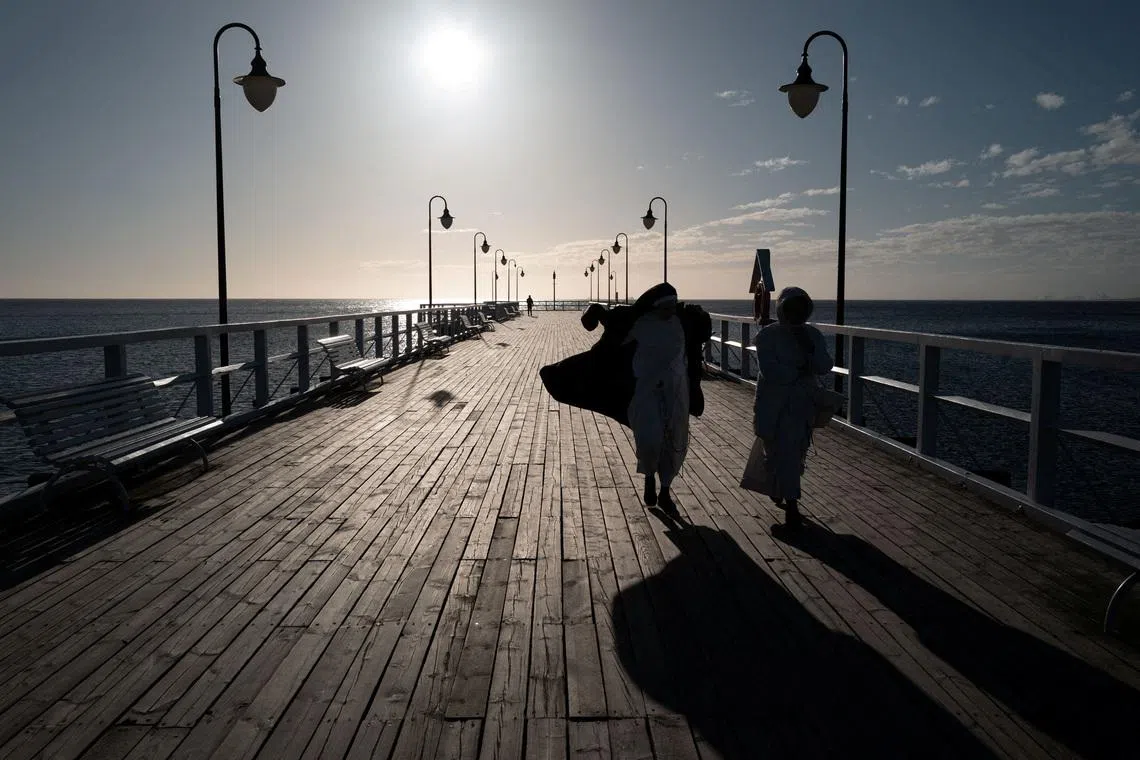 Nuns walking along Orlowo pier on a sunny spring morning in Gdynia, Poland, on April 7, 2026. 