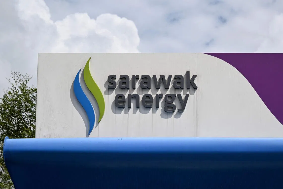 This picture taken on June 20, 2025 shows a logo of Sarawak Energy at an electric vehicle (EV) charging station in Kuching on the island of Borneo. Malaysia's verdant, river-crossed state of Sarawak is charging ahead with plans to become a regional "green battery," but its renewable energy dreams could come at serious environmental cost, experts warn. (Photo by Mohd RASFAN / AFP) / To go with Malaysia-Borneo-Sarawak-energy-electricity, FOCUS by Jan HENNOP