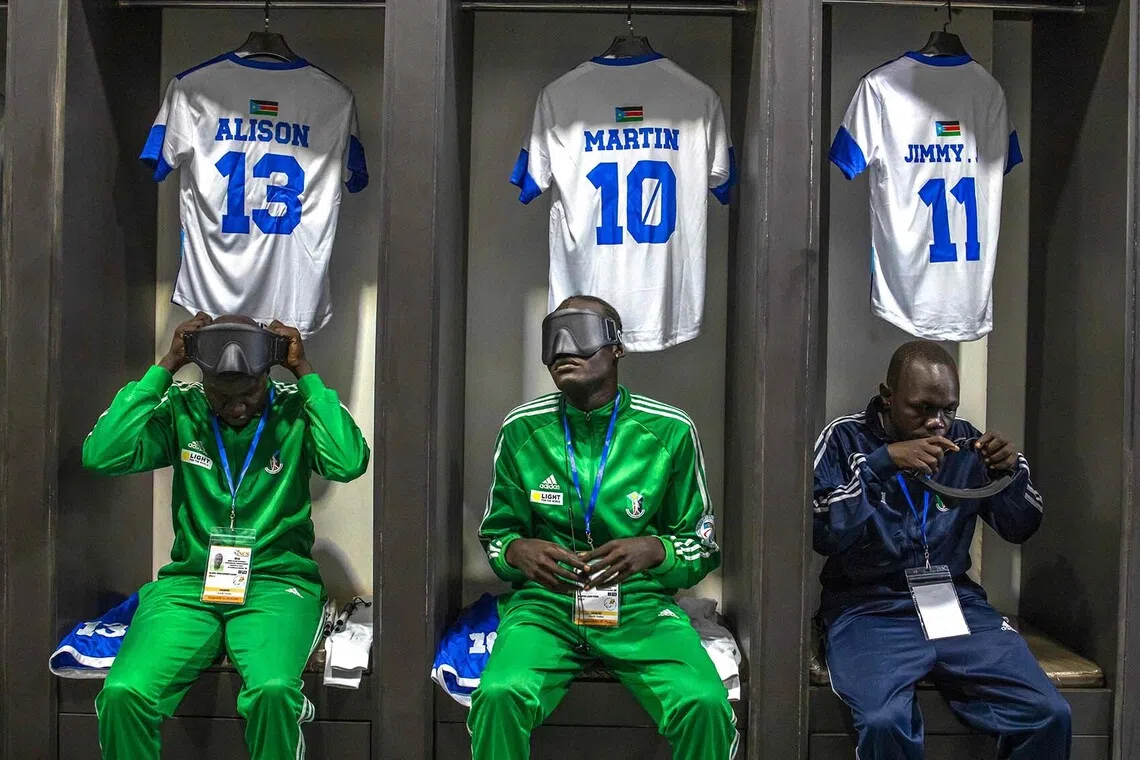 Players from South Sudan’s blind football team put on their uniforms in the locker room as they prepare for a match at Hamz Stadium Nakivubo War Memorial Grounds in Kampala, on Oct 27, 2025. 