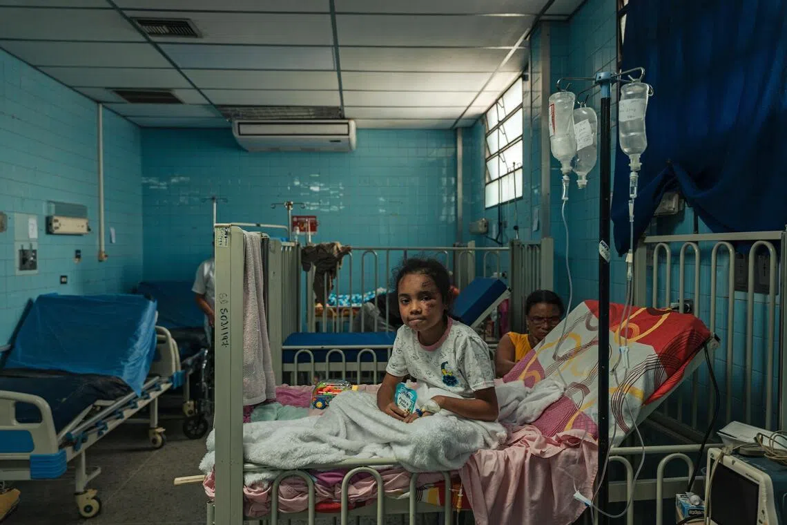 A young patient recovers in the emergency room of the Dr Ricardo Baquero Gonzalez Hospital in Caracas, Venezuela, on June 26.