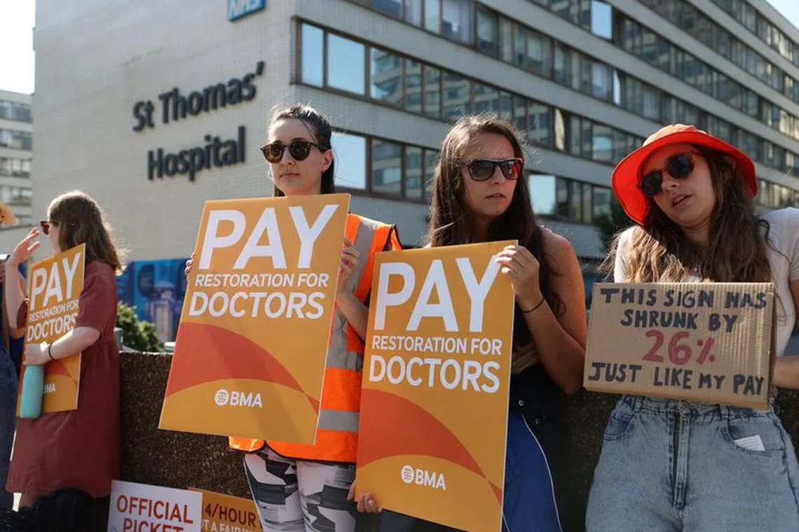 Demonstrators protest at a picket line outside of St Thomas' Hospital as junior doctors strike over pay and conditions, in London, Britain, June 14, 2023. REUTERS/Toby Melville/ File photo
