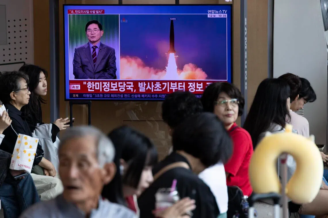 A TV screen broadcasts the news of North Korea’s launch of ballistic missiles at a station in Seoul on Oct 12.