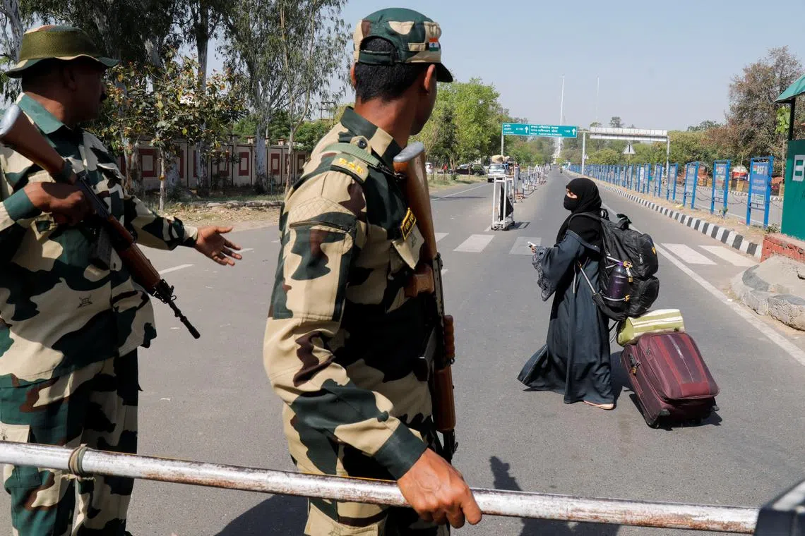 FILE PHOTO: A woman crosses a Border Security Force (BSF) checkpoint at the Attari-Wagah crossing on the India-Pakistan border near Amritsar, following Tuesday’s attack on tourists near south Kashmir’s scenic Pahalgam, India, April 25, 2025. REUTERS/Pawan Kumar/File Photo