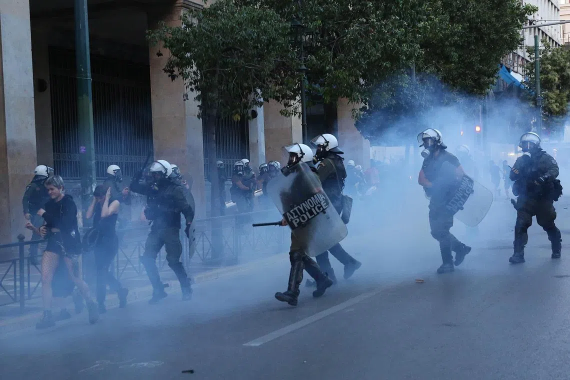 Police use tear gas to disperse pro-refugees activists protesting the loss of asylum seekers aboard a capsized boat, in Athens.