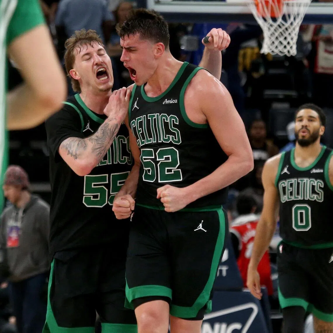 Boston Celtics guard Baylor Scheierman (left) and centre Luka Garza reacting during the 117-112 NBA victory over the Memphis Grizzlies on March 20 at FedExForum.
