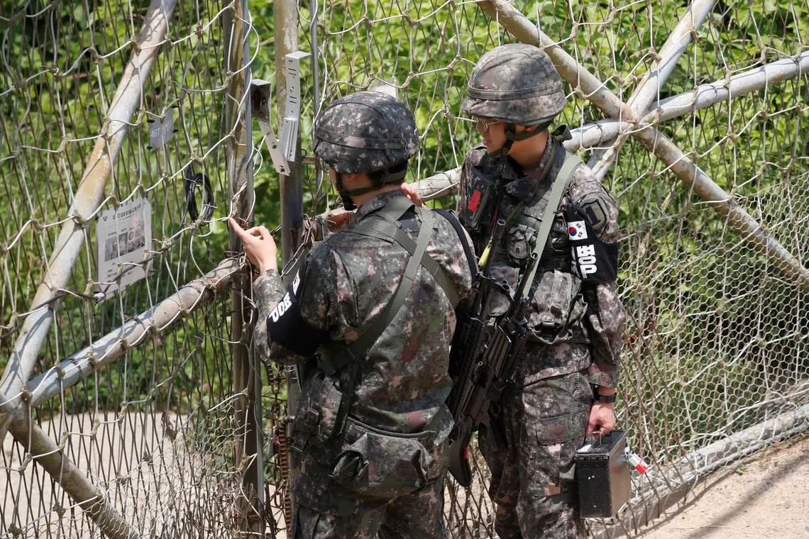 FILE PHOTO: South Korean soldiers lock a gate at a guard post near the the demilitarized zone (DMZ) separating the two Koreas, in Paju, South Korea, June 17, 2020. REUTERS/Kim Hong-Ji